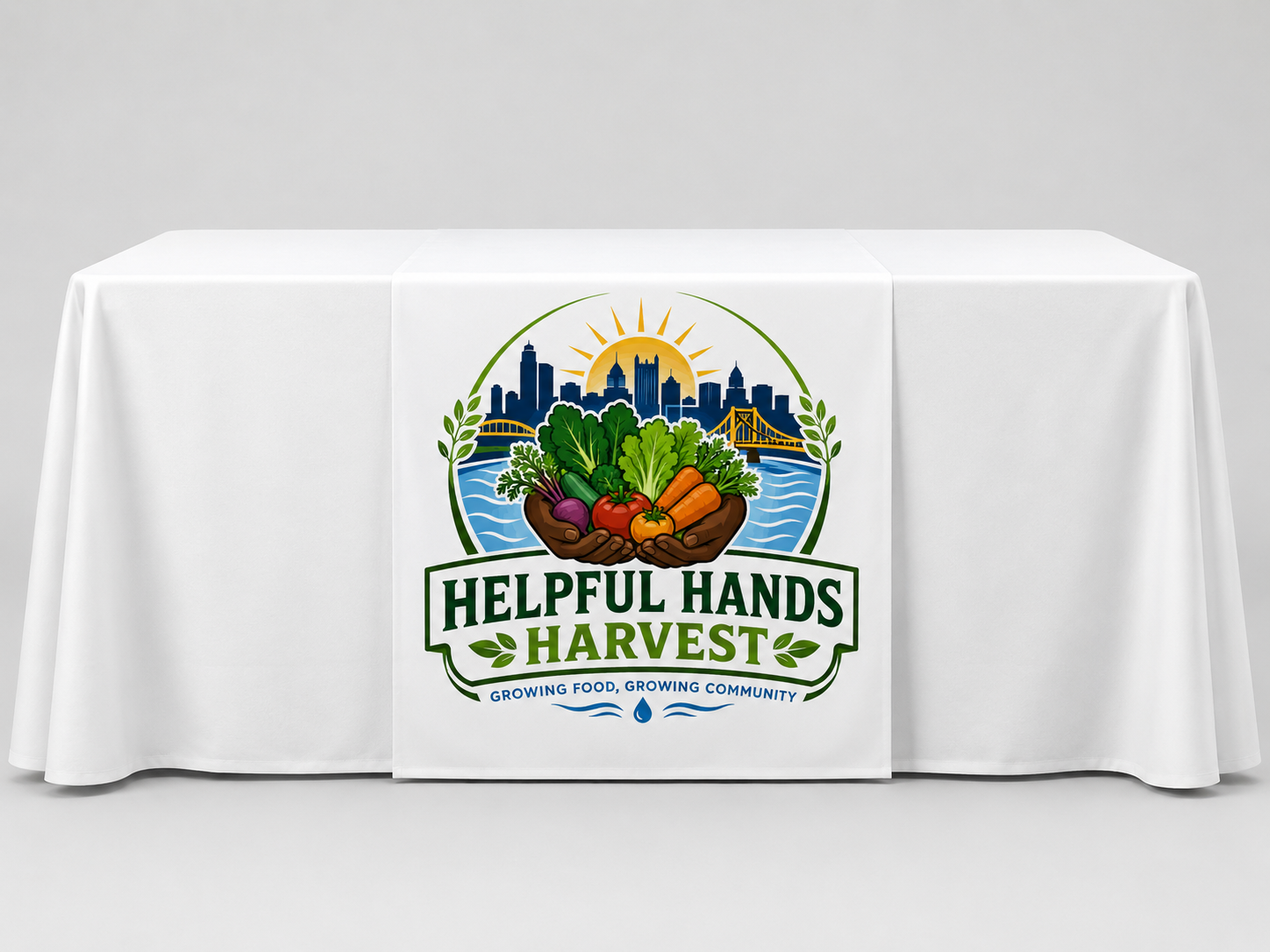 Helpful Hands Harvest outreach table with a centered branded table runner